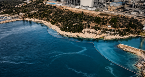 Zračni prikaz industrijskog područja Urinj uz obalu Kvarnera, s vidljivim tragovima onečišćenja u moru