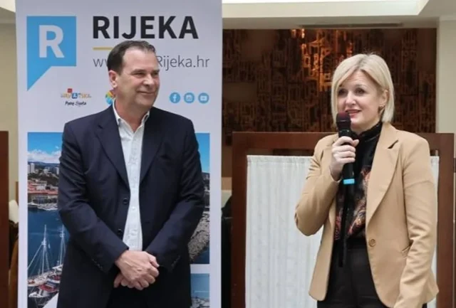 Gradonačelnica govori na događaju dok uz nju stoji direktor TZ, ilustracija uz vijest o blokadi izbora direktora Turističke zajednice Rijeke.